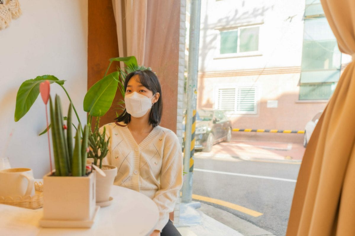 Korean girl in cafe wearing white-knit cardigan