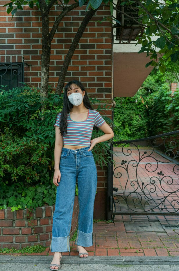 Korean woman with striped crop top and baggy jeans